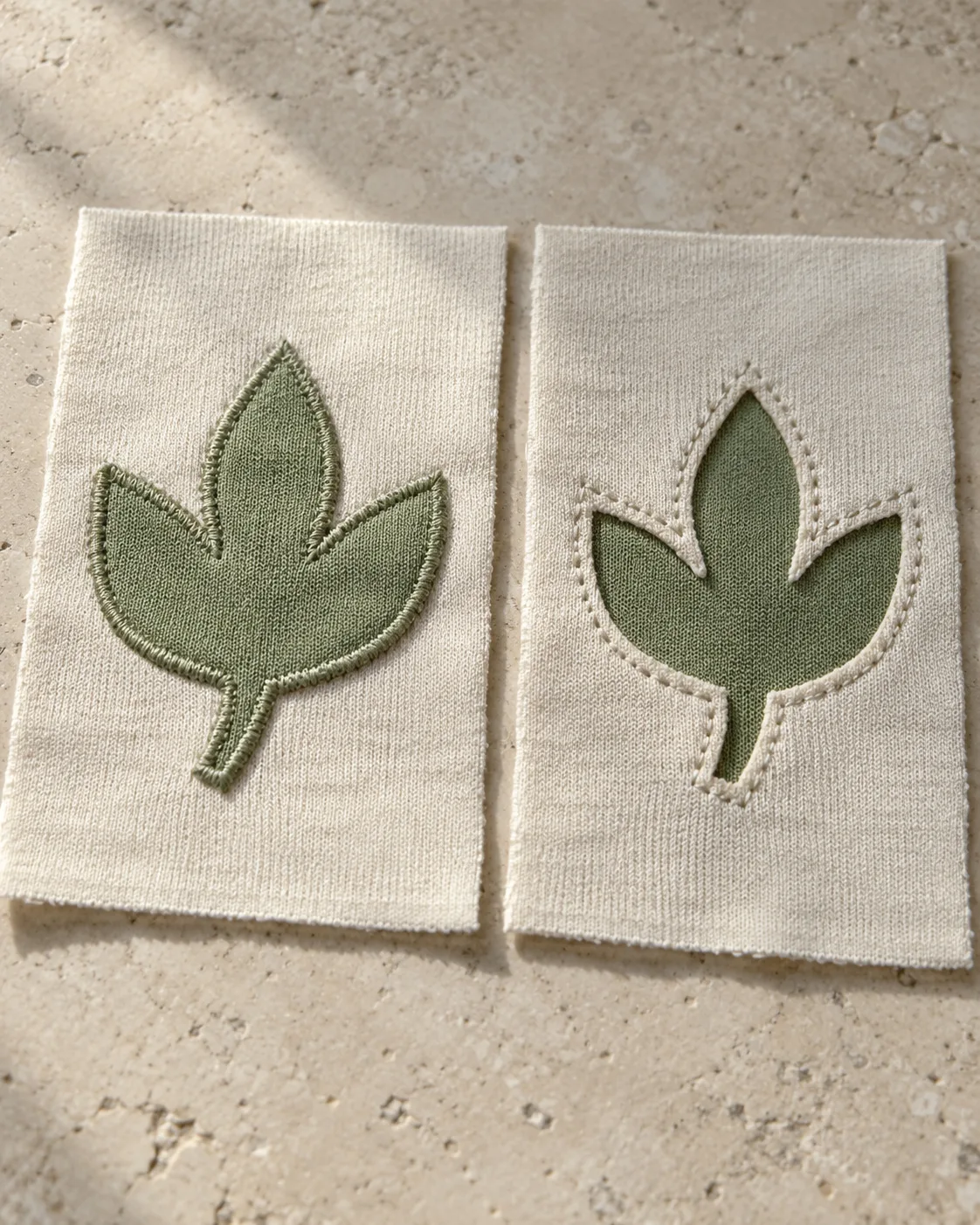 Two olive three-leaf motifs on ecru jersey: applied cloth on the left and cloth revealed through cut-away jersey on the right