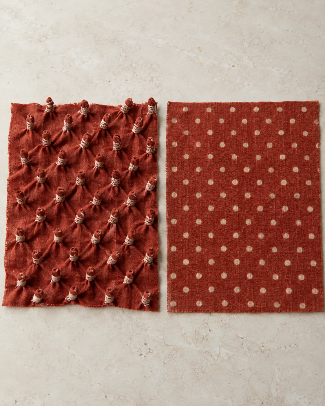 Rust-red cotton with thread-bound points on the left and printed cream dots on the right