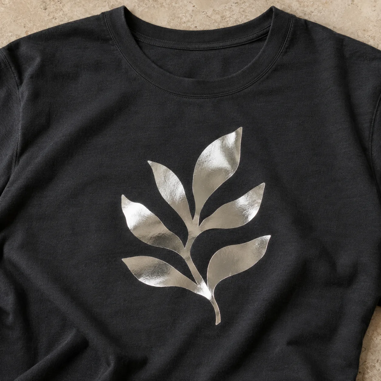 Silver foil leaf motif on black fabric