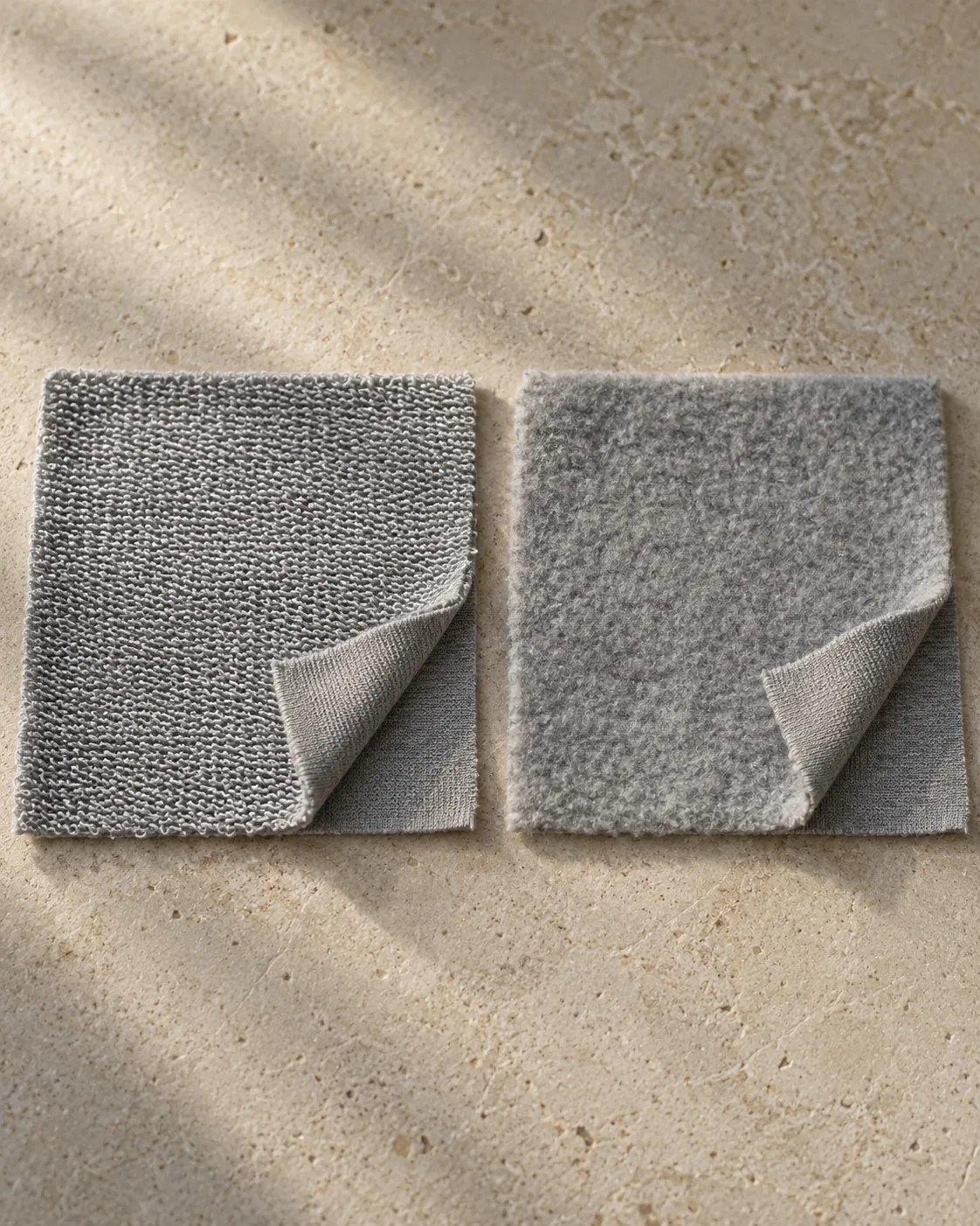 Two grey knit swatches: unbrushed French terry back floats on the left and raised fleece pile on the right, with corners folded to show the jersey faces