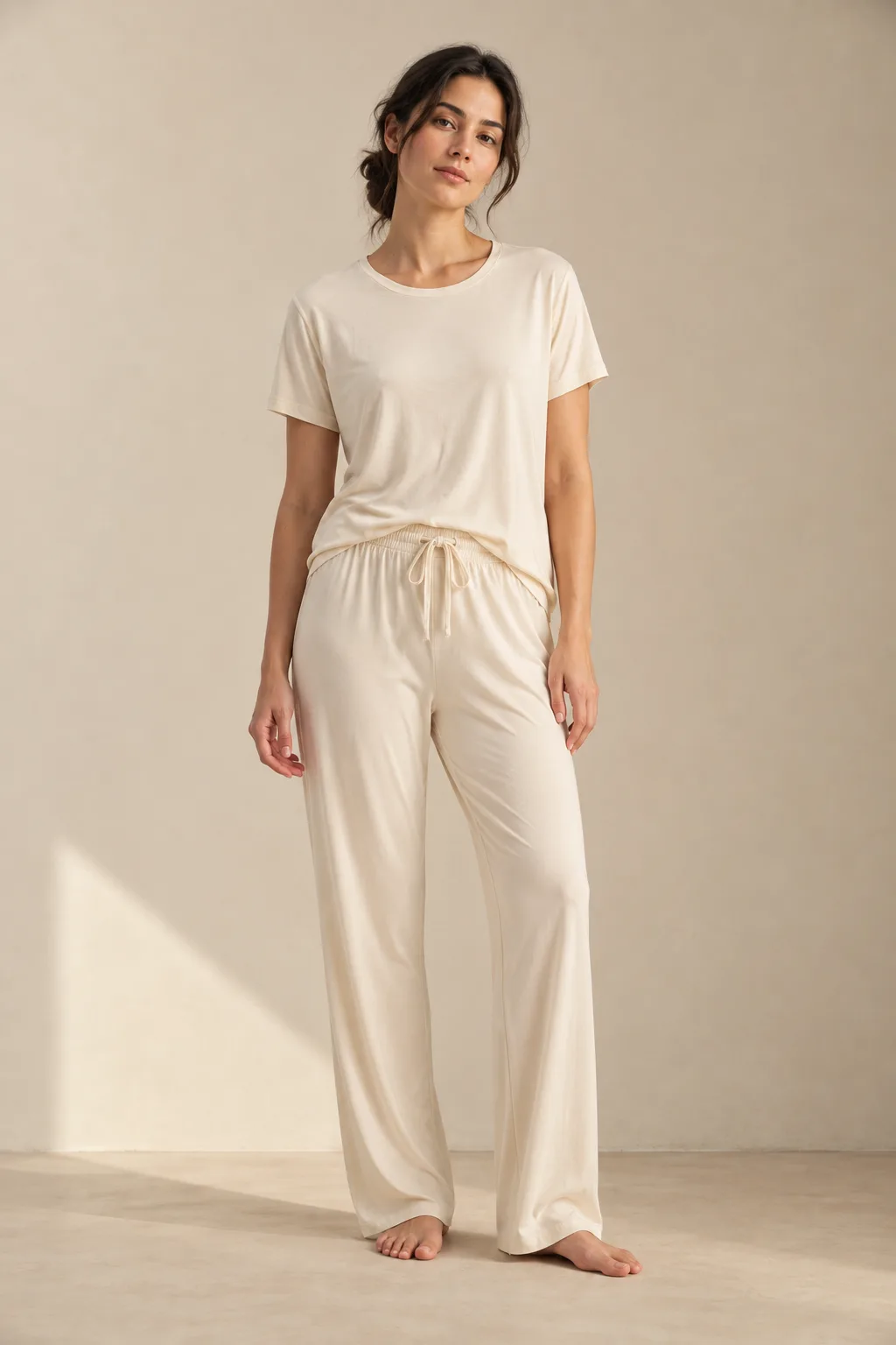 Woman wearing a cream T-shirt and drawstring lounge trousers