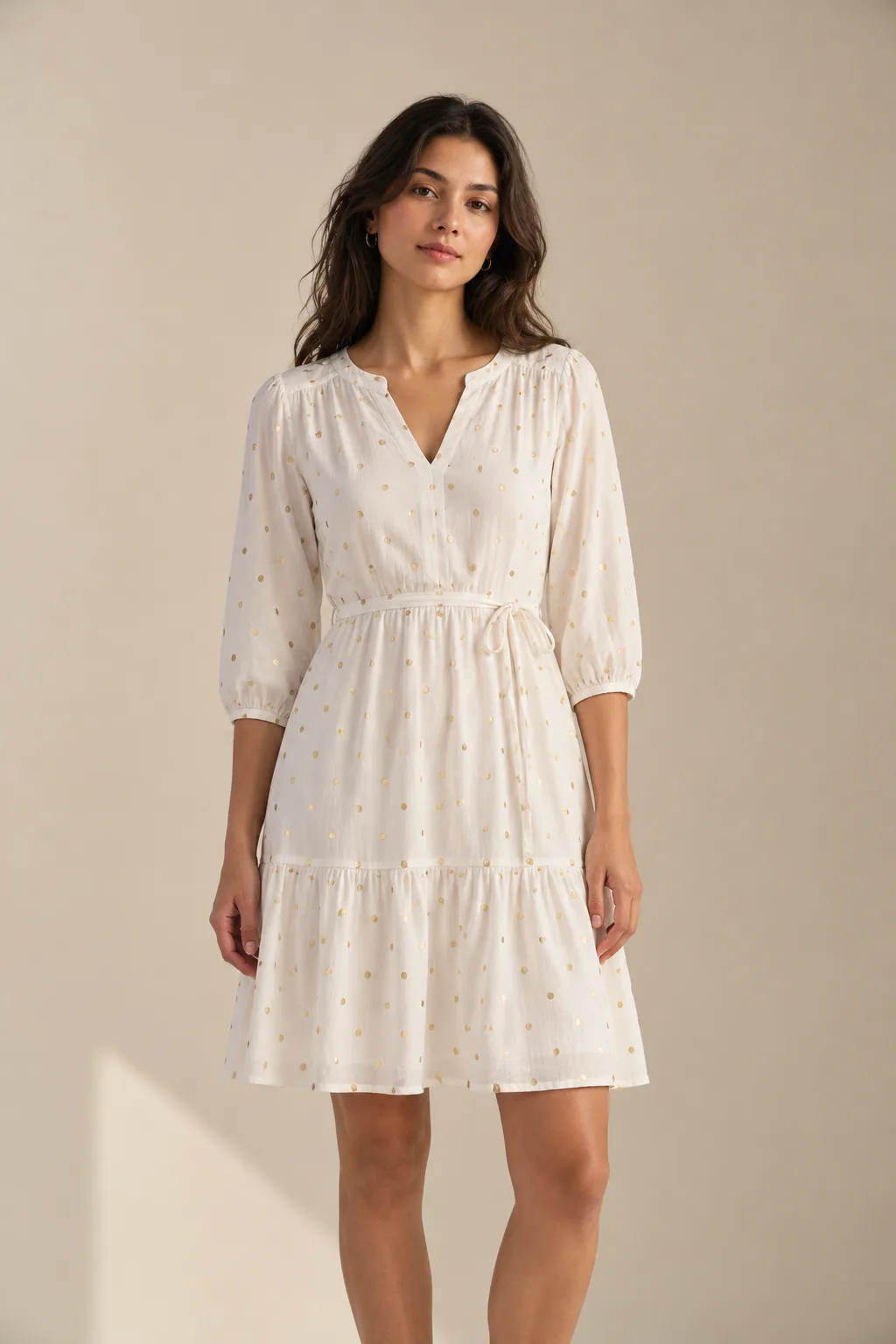 White tiered dress with three-quarter sleeves, scattered with small gold foil dots