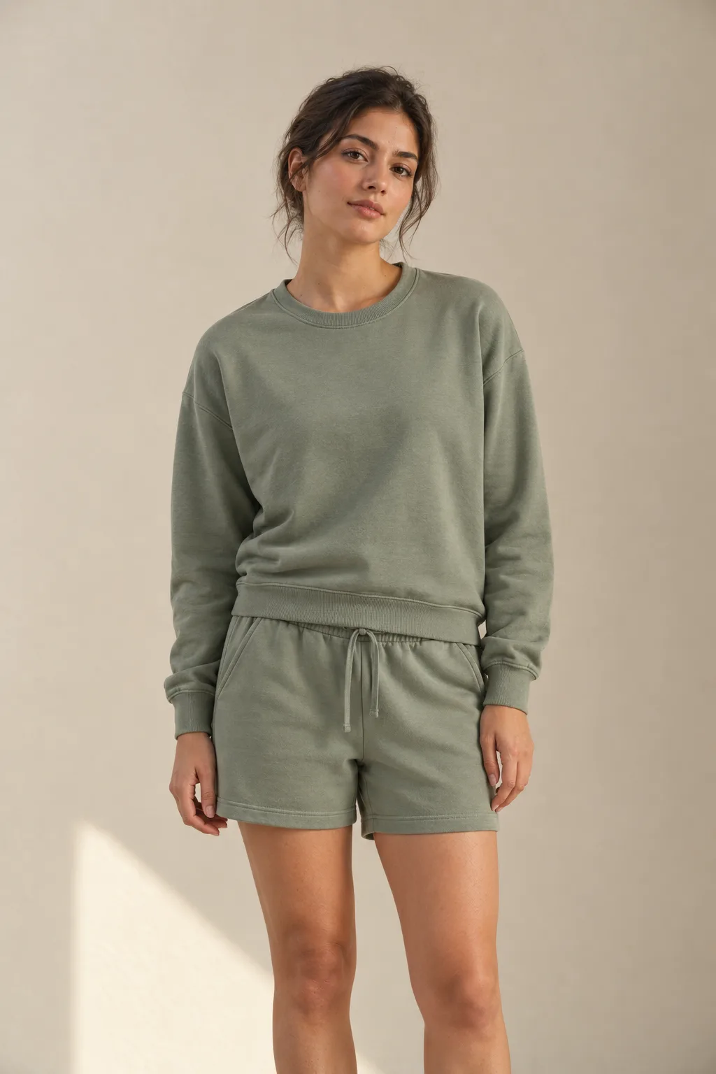 Woman wearing a sage French terry sweatshirt and shorts set