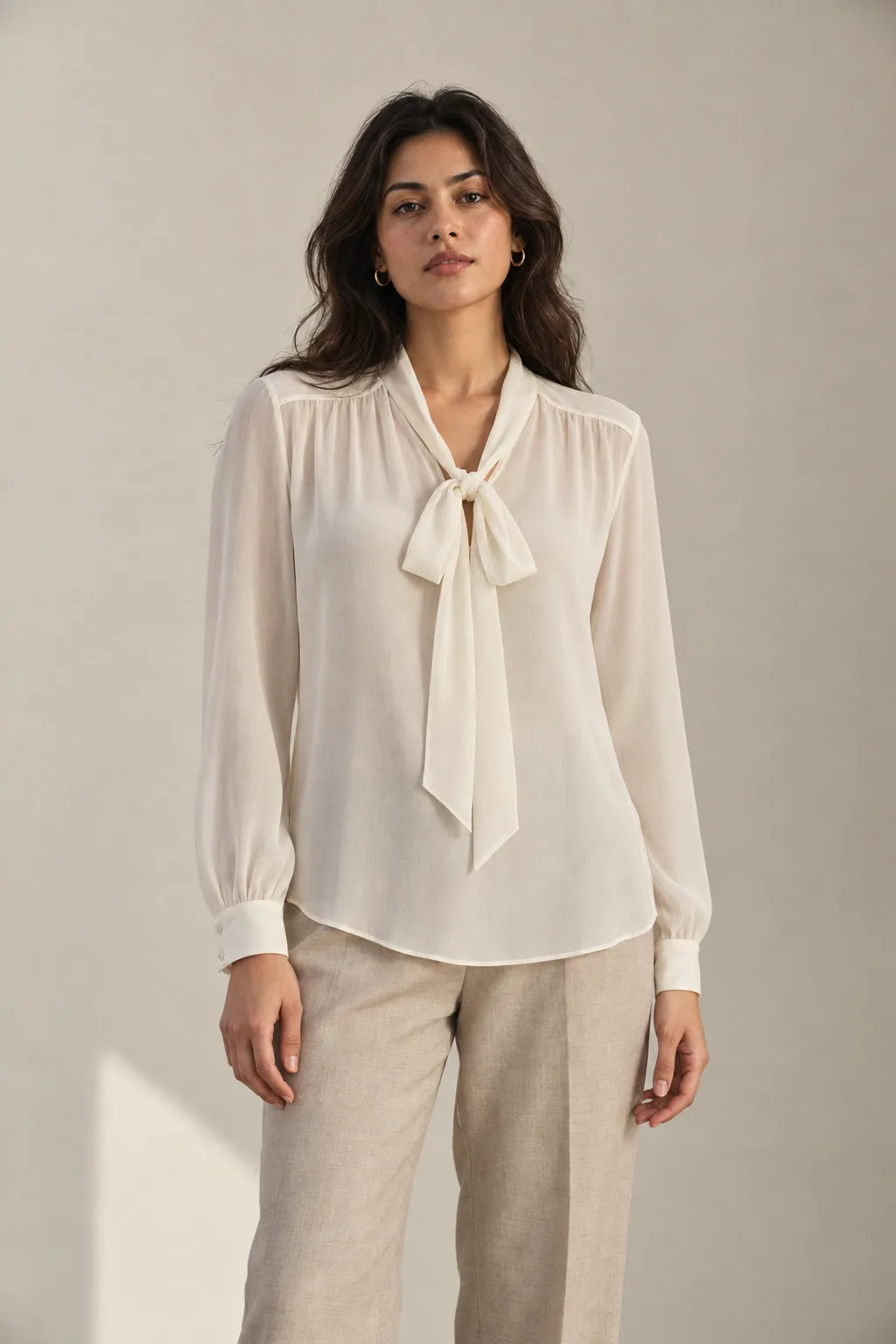 Ivory georgette blouse with a tie neck and long sleeves
