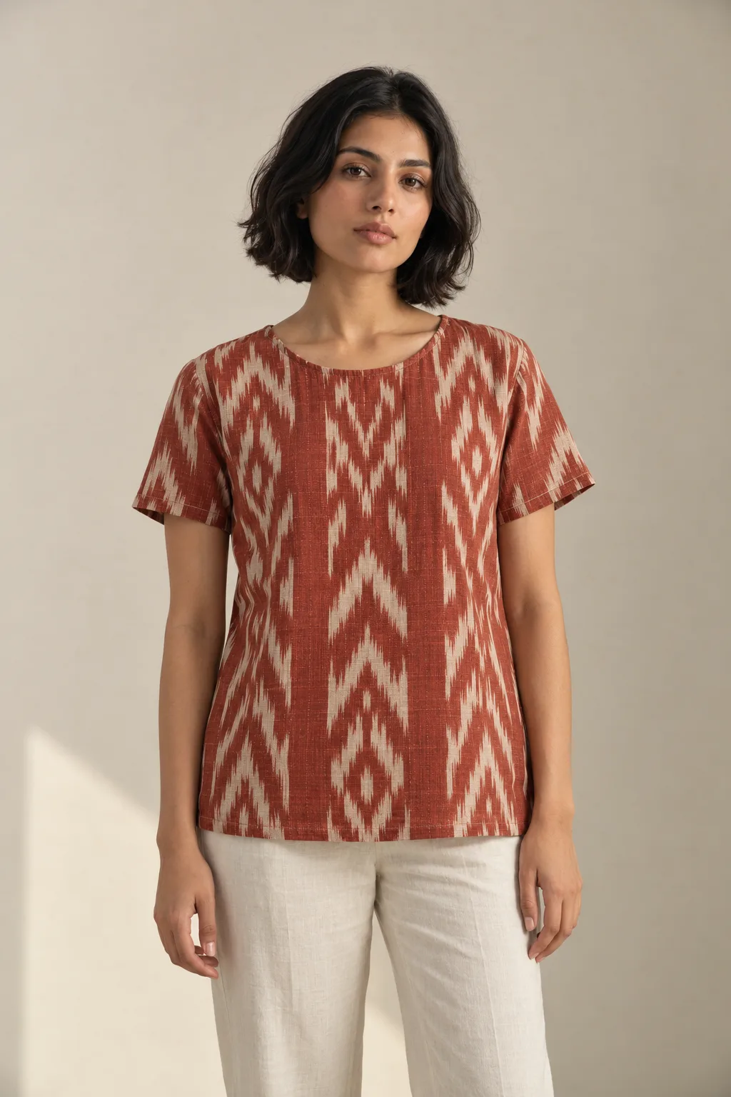 Rust and cream short-sleeved ikat top with diamond motifs