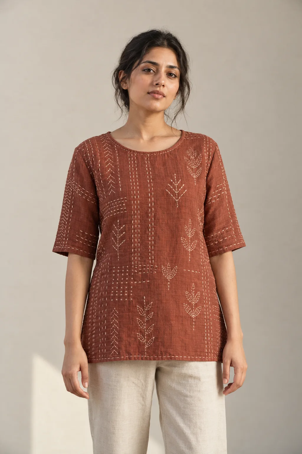 Rust top with cream Kantha leaf motifs and running-stitch rows