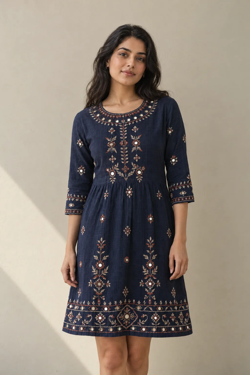 Navy dress with mirrors and thread embroidery around the neckline and upper front