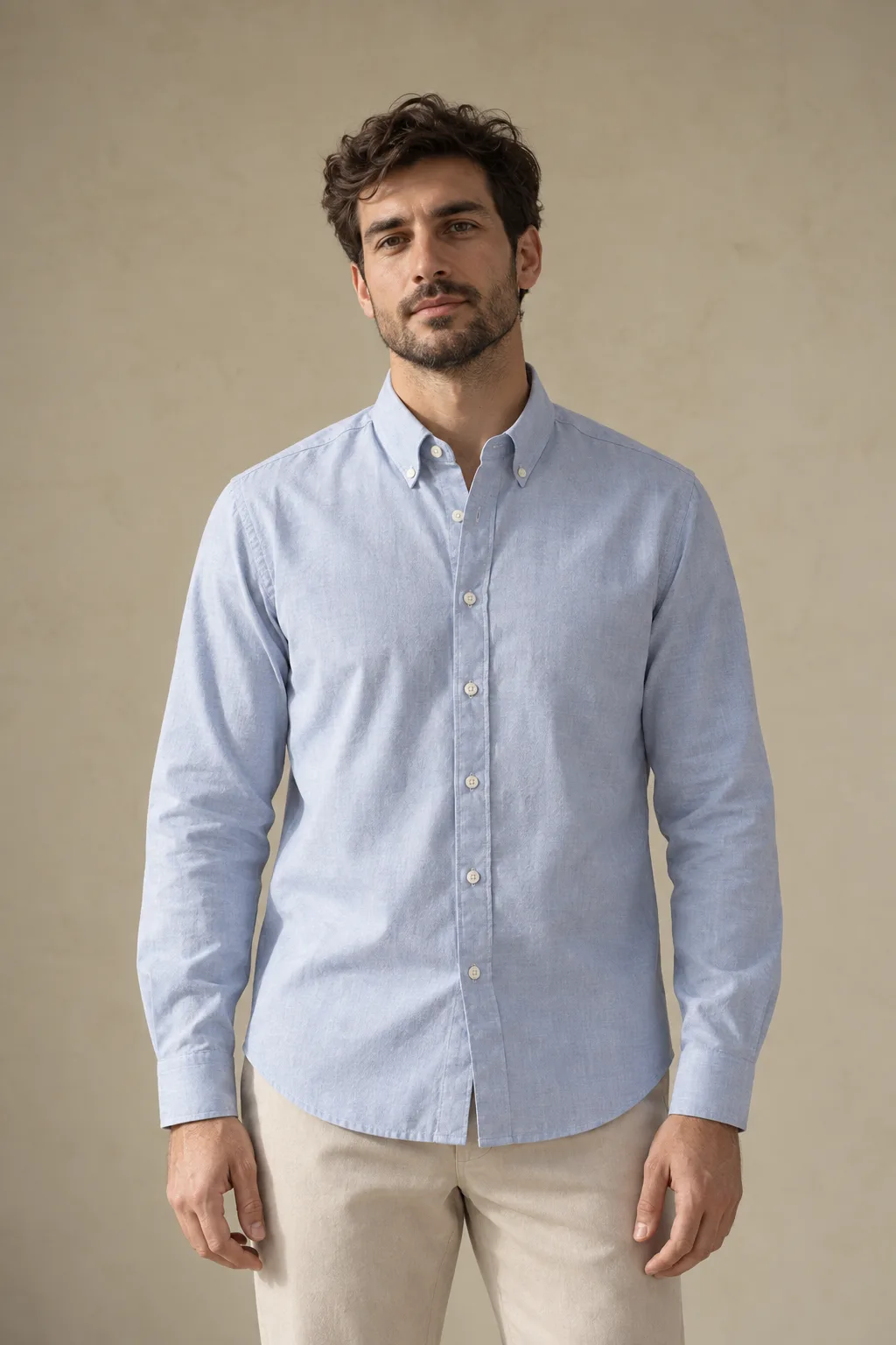 Man wearing a light blue Oxford shirt with a button-down collar