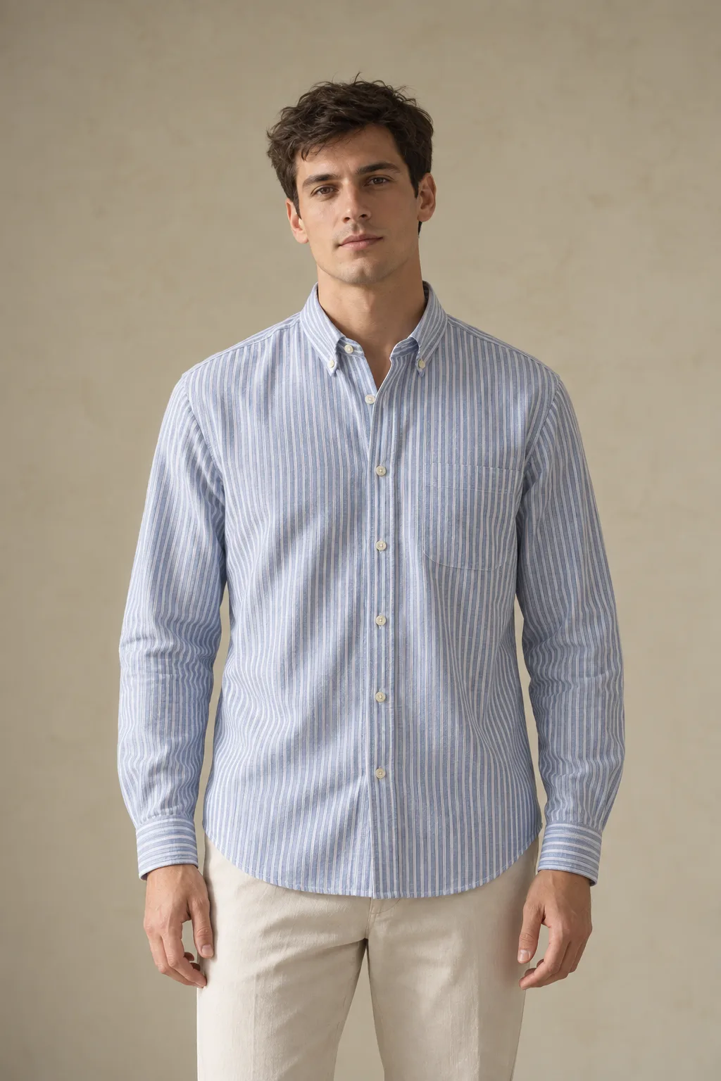 Man wearing a blue-and-white striped Oxford shirt with a chest pocket
