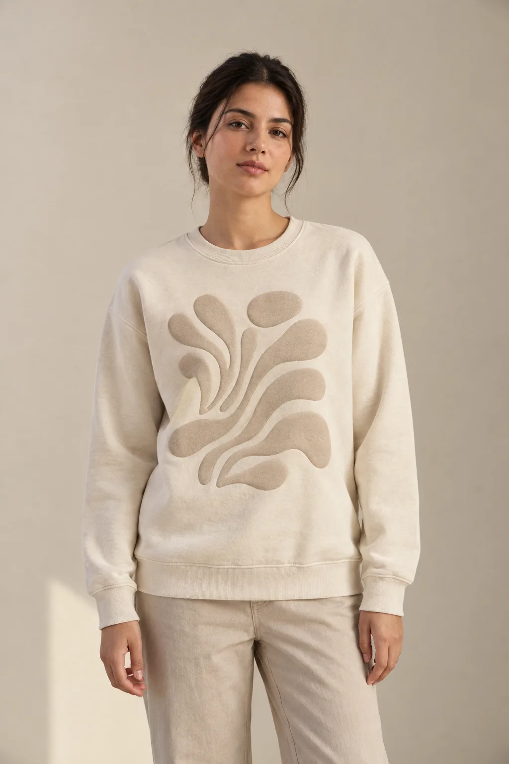 Cream sweatshirt with a large raised beige puff-print motif