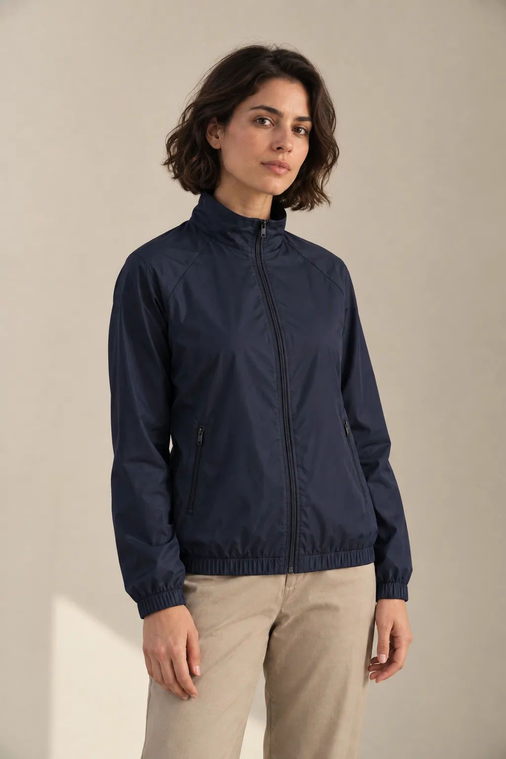 Woman wearing a navy zip-front track jacket