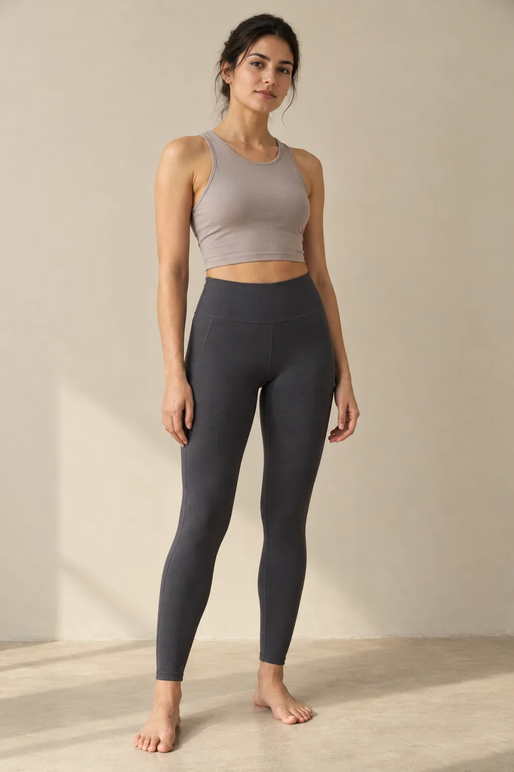 Woman wearing charcoal leggings with a wide waistband