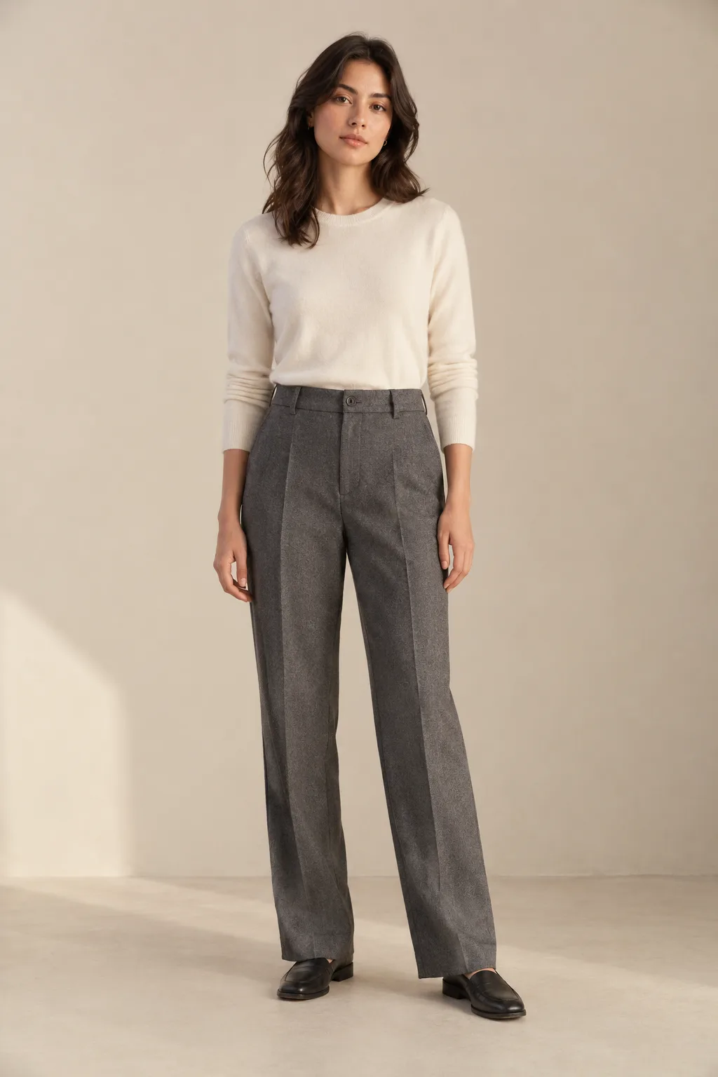 Woman wearing grey tailored trousers with pressed creases