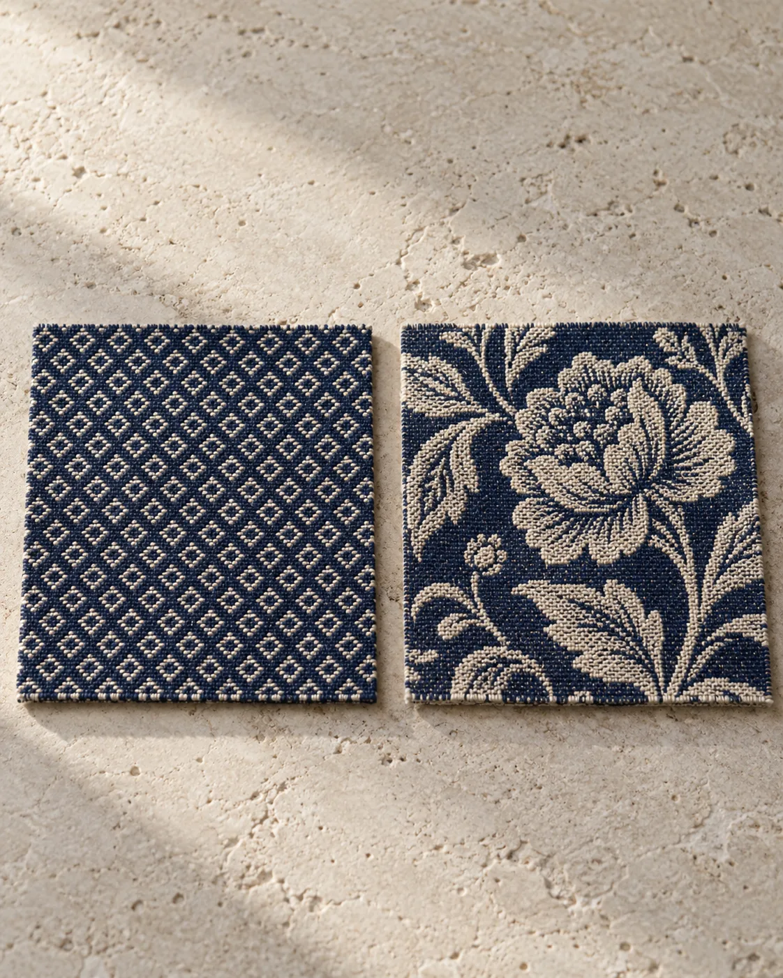 Navy and ecru woven swatches, with small dobby diamonds on the left and a large jacquard floral on the right