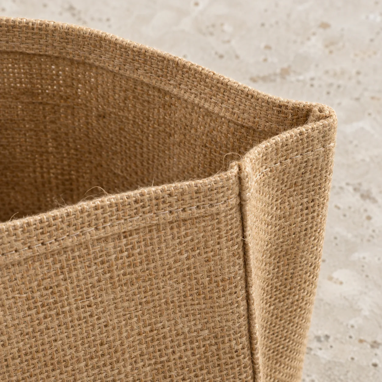 Inside top hem and sewn gusset seam of a natural jute hessian tote
