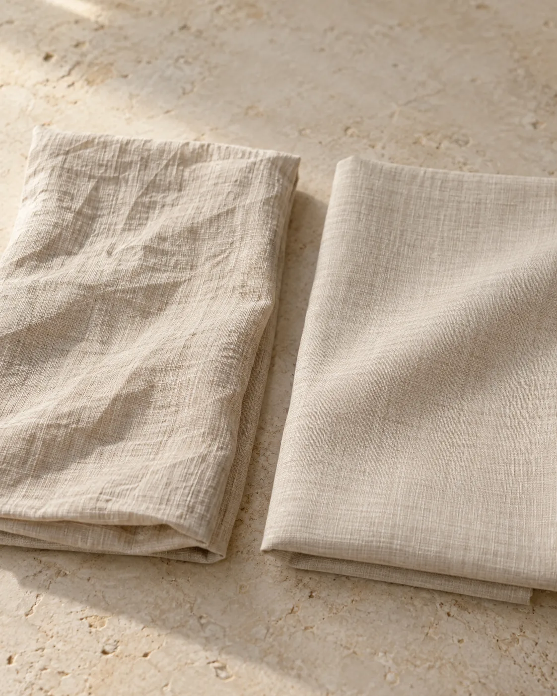 Two oatmeal shirting swatches: creased 100% linen on the left, a smoother linen and cotton blend on the right