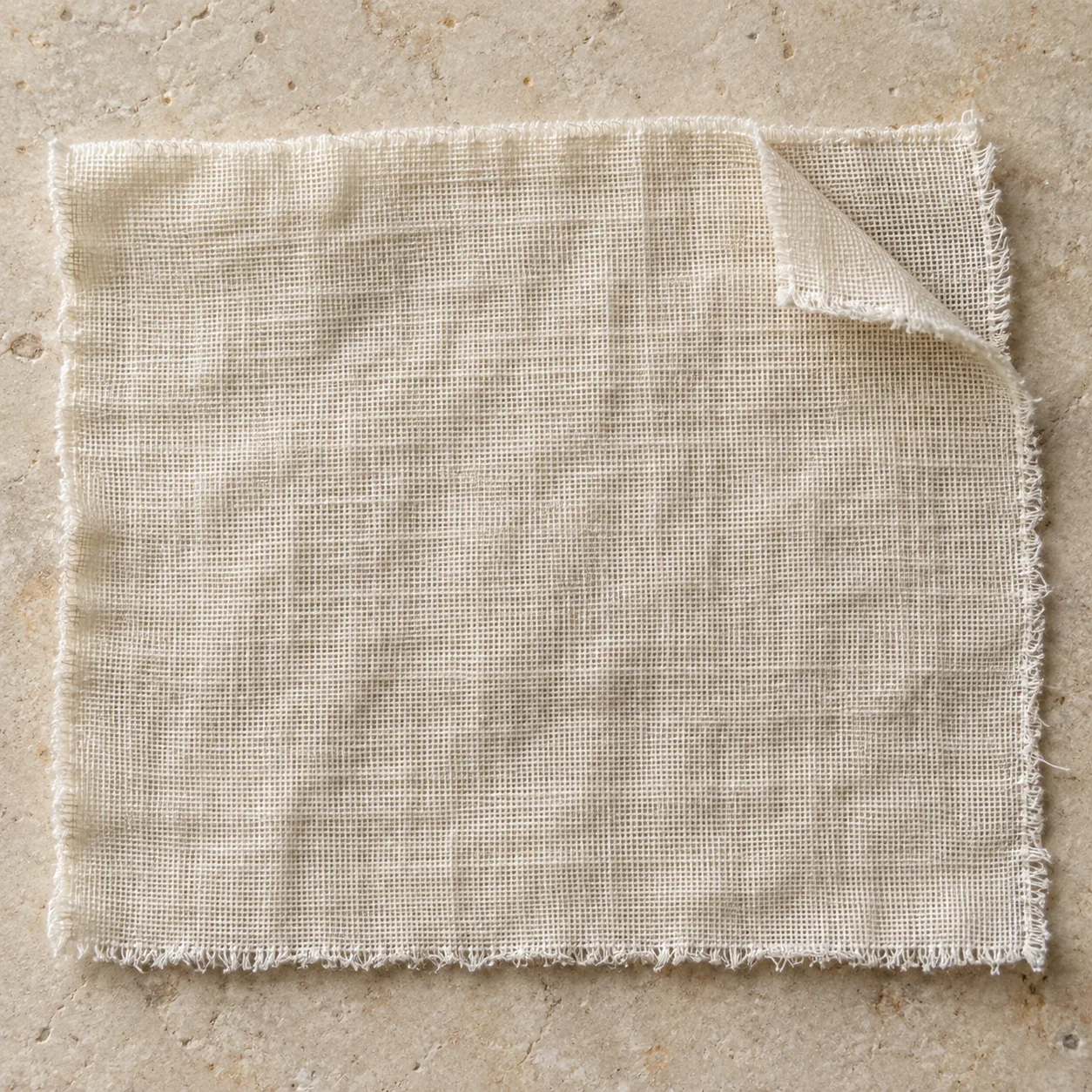 Ecru double-gauze swatch with a raw corner turned back to reveal two layers