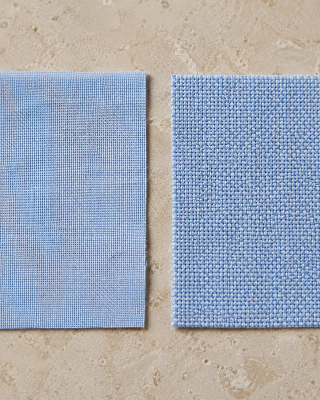 Pale blue fine plain-weave poplin beside pale blue basket-weave Oxford