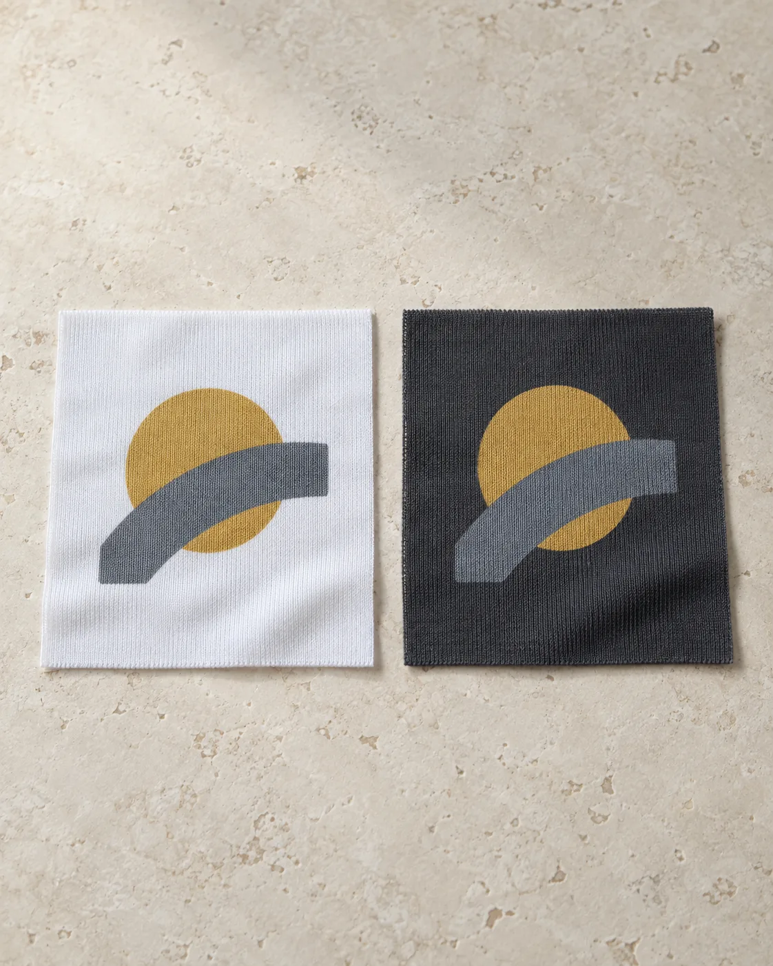 White and charcoal polyester jersey swatches with the same mustard circle and slate curved stripe