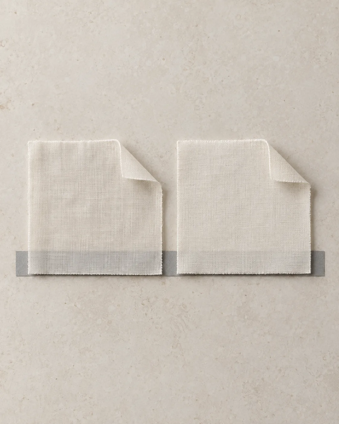 White cotton voile and lawn squares side by side over a grey strip